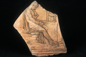 Tablet depicting a man sitting beside an alter