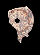 Fragment of an oil lamp decorated with a 12-petaled flower