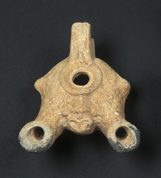 Oil lamp with two nozzles depicting a theatrical mask